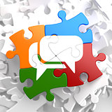 White Speech Bubble Icon on Multicolor Puzzle.