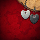 Two Stone Hearts on Red Floral Background