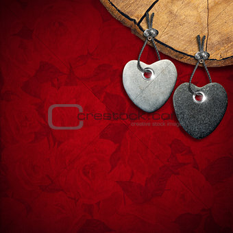 Two Stone Hearts on Red Floral Background