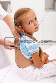 Little girl at the doctor for an examination