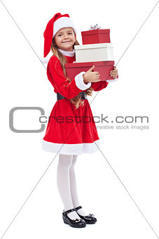 Happy girl in santa outfit holding presents