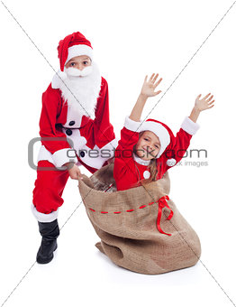 Christmas surprise- kids dressed as santa and his helper
