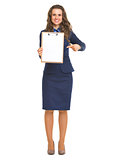 Full length portrait of smiling business woman pointing on blank