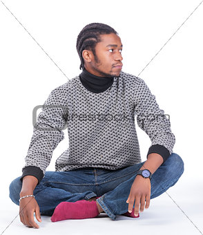 Young African-American male sitting on the ground