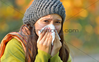 girl with allergy or cold using tissue