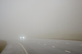 Road and a car in fog
