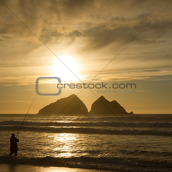 Fisherman silhouette at sunset 