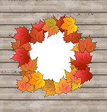 Autumn leaves maple with copy space, wooden texture