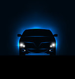Silhouette of car with headlights in darkness 