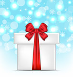 Gift box with red bows on glowing background