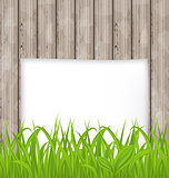 Green grass and paper sheet on wooden texture