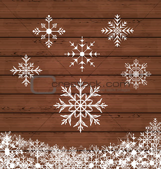 Set snowflakes on wooden texture