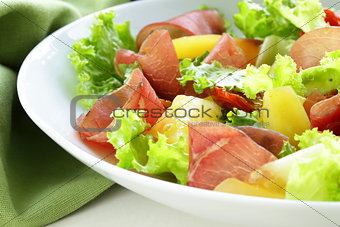 fresh green snack salad with ham and vegetables