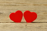 Two red heart, symbol of love on a wooden background