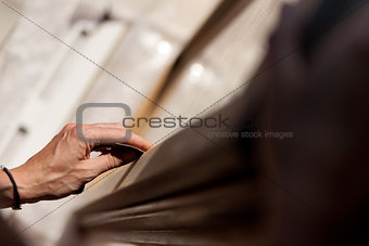Hand of a woman sanding fixtures