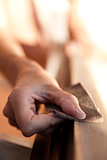 Hand of a woman sanding fixtures