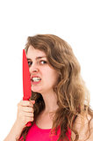woman is holding a knife close to her face