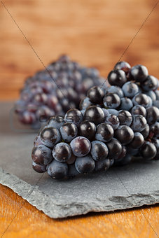 Blue grape clusters on slate board