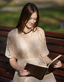 Young cute lady sitting on bench