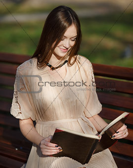 Young cute lady sitting on bench