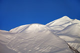 Off-piste slope and blue clear sky in nice winter morning