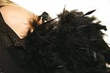women's shoulder with black feather boa
