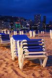 Empty beach with sunbeds by night