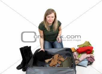 girl is packing clothes