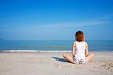 woman meditating facing to the sea