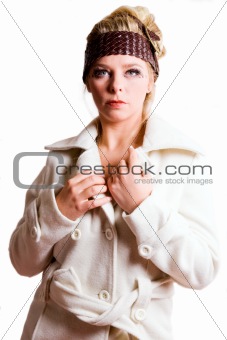 Fashion portrait of a blond girl in a white coat