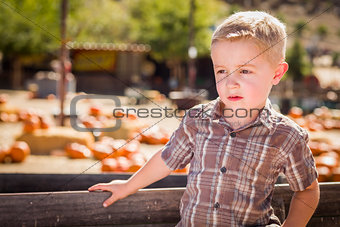 Little Boy Standing Against Old Wood Wagon at Pumpkin Patch 