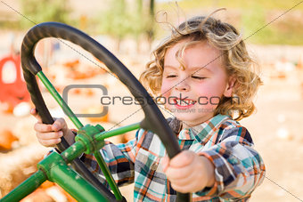 Adorable Young Boy Playing on an Old Tractor Outside