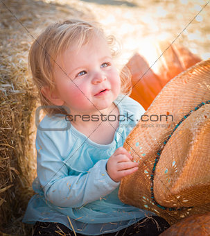 Adorable Baby Girl with Cowboy Hat at the Pumpkin Patch 