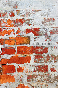 Old brick wall covered with cement and lime
