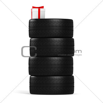 Four New Car Tires and White Gift with Red Ribbon On the White
