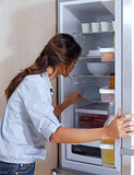 woman looking in the fridge