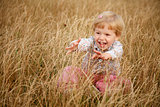 little girl playing in the grass