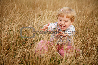little girl playing in the grass