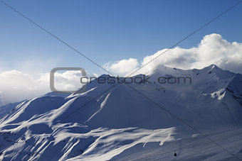 View on ski slope and sunlight mountains in evening