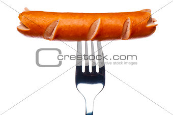Cooking sausage on a fork on a white background