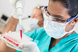 Asian Female Laboratory Scientist Pipette & Blood Sample
