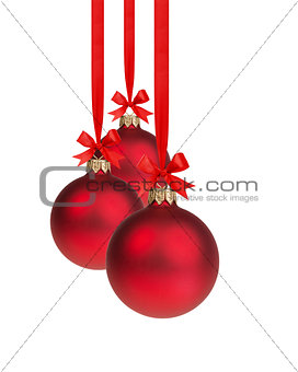 composition from three red christmas balls hanging on ribbon
