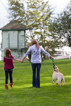 Mom And daughter walking the dog