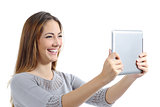 Beautiful woman laughing watching a digital tablet