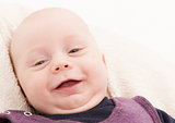 newborn child laughing to camera