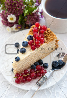 Piece of homemade honey cake with fresh berries