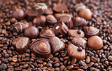 Assorted chocolate pralines on coffee beans background