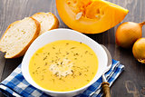 Pumpkin soup in white bowl