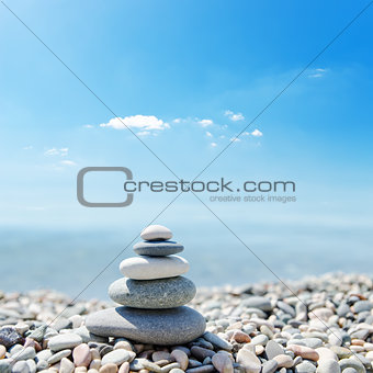 stack of zen stones over sea and clouds background