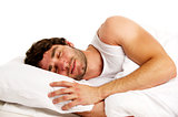 Man laid in white bed sleeping